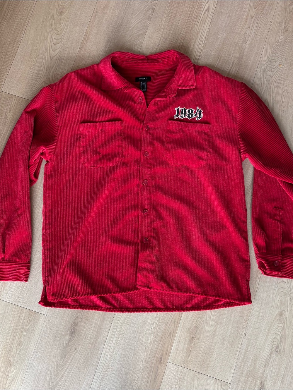 red corduroy button up shirt with 1984 embroidery